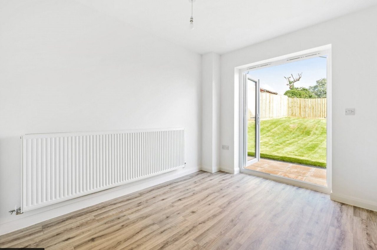 Image of dining room space, with patio doors open leading out to the rear garden.