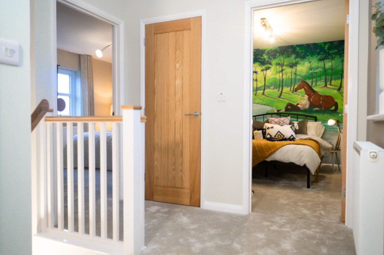 Hallway, leading onto the homes third bedroom which is decorated for a child.